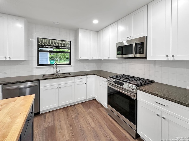 543 Cosgrove, San Antonio, TX 78210 - kitchen with stainless steel appliances, butcher block counters, backsplash, white cabinets, and recessed lighting