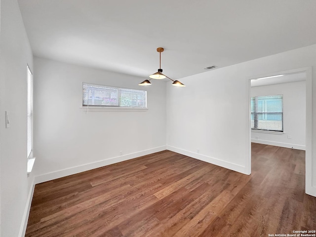 543 Cosgrove, San Antonio, TX 78210 - spare room featuring plenty of natural light and wood finished floors