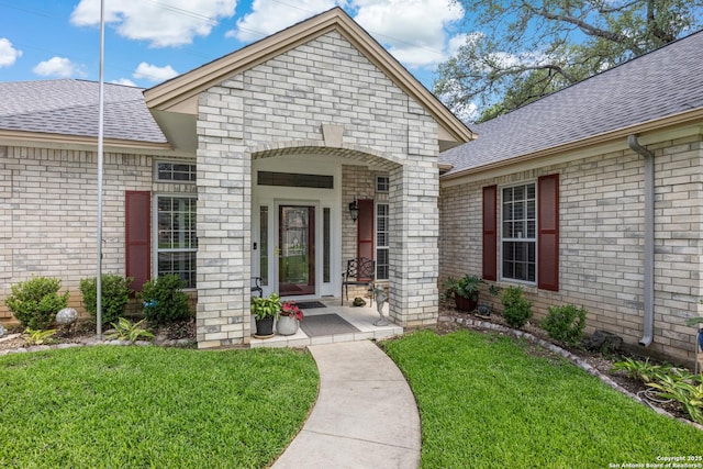 8526 Spartan Ter, Universal City, TX 78148 - doorway to property featuring roof with shingles, brick siding, and a lawn