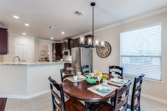 3415 Crest Noche Dr, San Antonio, TX 78261 - dining space featuring arched walkways, ornamental molding, plenty of natural light, recessed lighting, and light tile patterned floors