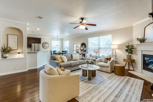 3415 Crest Noche Dr, San Antonio, TX 78261 - living area with hardwood / wood-style floors, ceiling fan, crown molding, a glass covered fireplace, and plenty of natural light