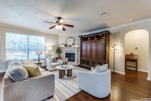 3415 Crest Noche Dr, San Antonio, TX 78261 - living room featuring arched walkways, ceiling fan, wood-type flooring, crown molding, and a textured ceiling