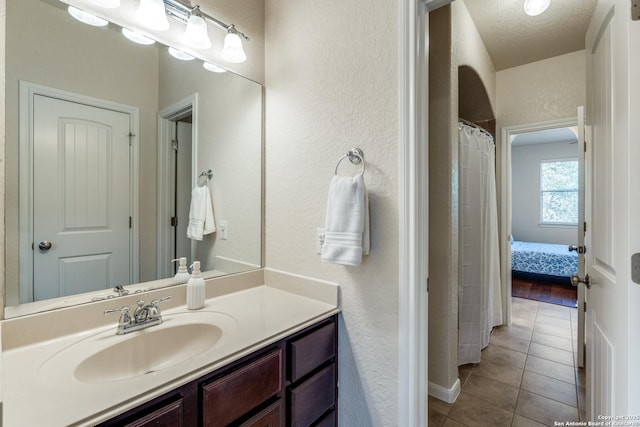 3415 Crest Noche Dr, San Antonio, TX 78261 - full bathroom featuring a textured wall, tile patterned flooring, vanity, and a textured ceiling
