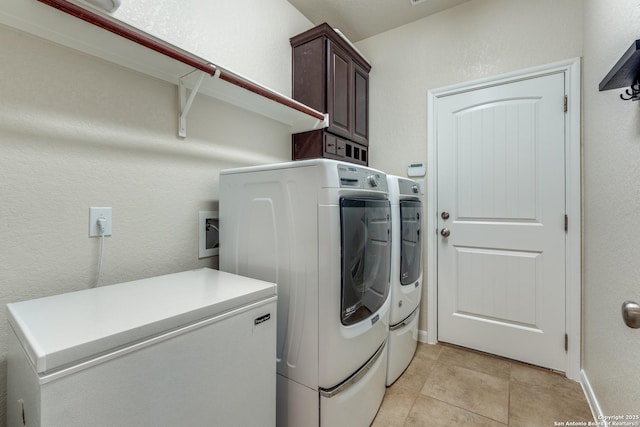 3415 Crest Noche Dr, San Antonio, TX 78261 - laundry room with cabinet space, washer and clothes dryer, light tile patterned floors, and a textured wall