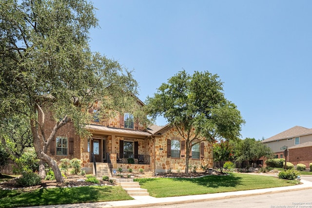 3415 Crest Noche Dr, San Antonio, TX 78261 - view of front facade featuring covered porch, stone siding, and a standing seam roof