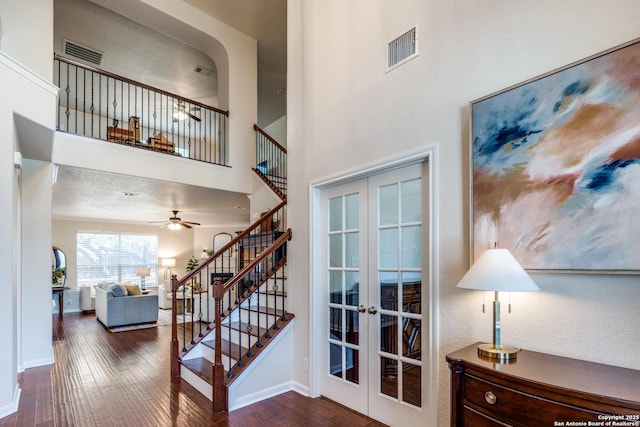 3415 Crest Noche Dr, San Antonio, TX 78261 - staircase featuring french doors, wood finished floors, ceiling fan, and a towering ceiling