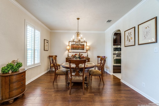 3415 Crest Noche Dr, San Antonio, TX 78261 - dining room featuring arched walkways, crown molding, dark wood-type flooring, and a chandelier