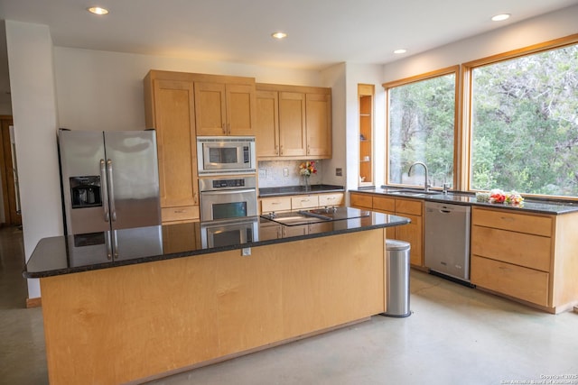 317 Saddle Mtn, Boerne, TX 78006 - kitchen with stainless steel appliances, recessed lighting, dark stone counters, backsplash, and a center island