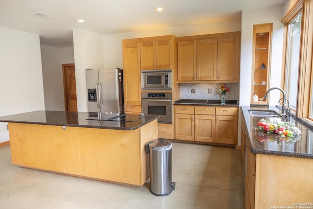 317 Saddle Mtn, Boerne, TX 78006 - kitchen featuring stainless steel appliances, finished concrete flooring, dark stone countertops, decorative backsplash, and a center island