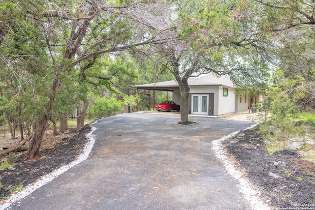 317 Saddle Mtn, Boerne, TX 78006 - view of front facade with french doors, asphalt driveway, stucco siding, and an attached carport