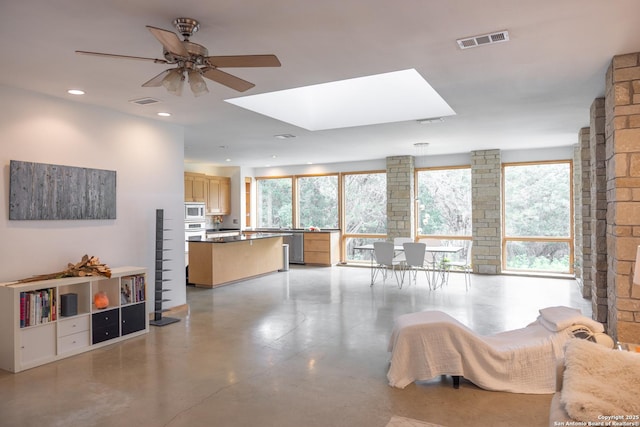 317 Saddle Mtn, Boerne, TX 78006 - living room with ceiling fan, healthy amount of natural light, a skylight, concrete floors, and recessed lighting