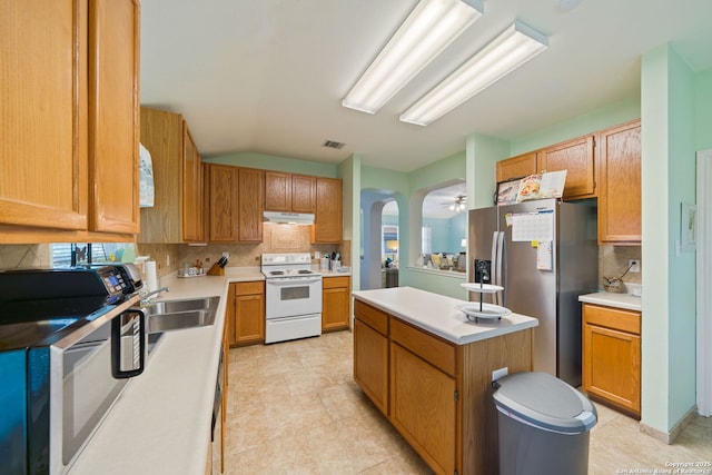5327 Stormy Skies, San Antonio, TX 78247 - kitchen with white electric range oven, stainless steel fridge with ice dispenser, under cabinet range hood, tasteful backsplash, and a kitchen island