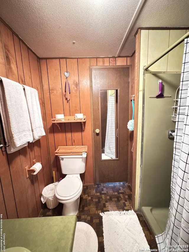 323 N Scenic Loop, Canyon Lake, TX 78133 - full bathroom featuring a textured ceiling, curtained shower, and wooden walls