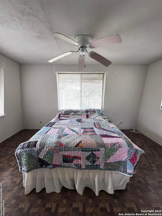 323 N Scenic Loop, Canyon Lake, TX 78133 - bedroom with a textured ceiling and ceiling fan