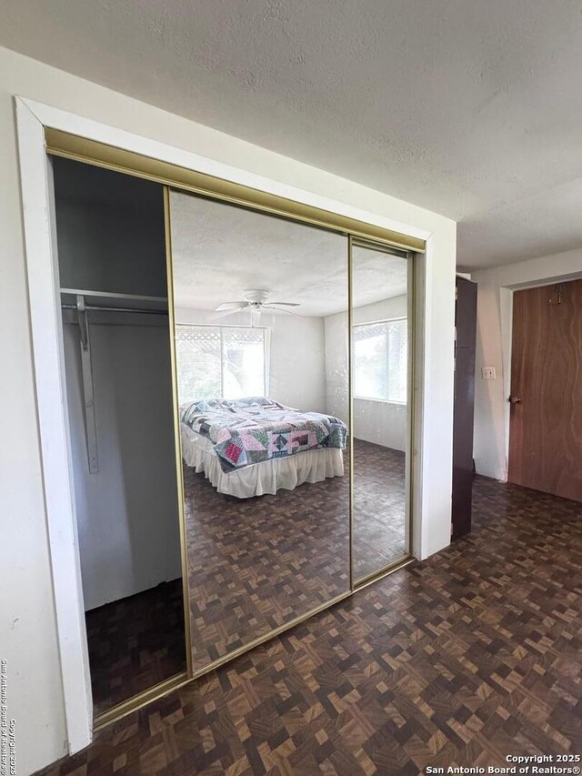 323 N Scenic Loop, Canyon Lake, TX 78133 - bedroom with a textured ceiling