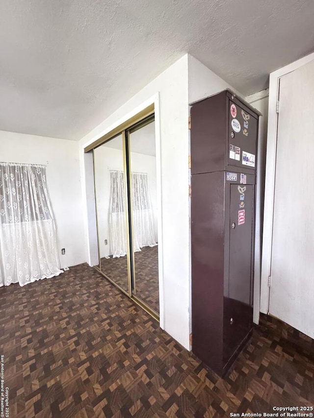 323 N Scenic Loop, Canyon Lake, TX 78133 - unfurnished bedroom with a closet and a textured ceiling