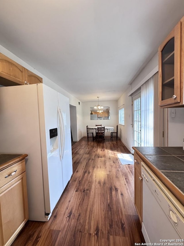 323 N Scenic Loop, Canyon Lake, TX 78133 - kitchen featuring white appliances, glass insert cabinets, a chandelier, dark wood finished floors, and tile countertops