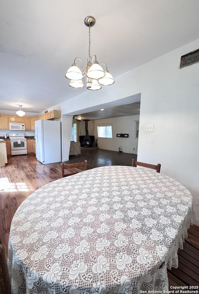323 N Scenic Loop, Canyon Lake, TX 78133 - dining area featuring wood finished floors and a chandelier