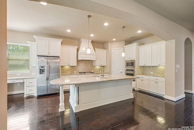 1702 Terra Alta, San Antonio, TX 78209 - kitchen featuring appliances with stainless steel finishes, custom range hood, dark wood finished floors, white cabinetry, and backsplash