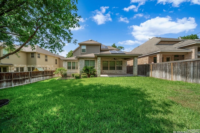 1702 Terra Alta, San Antonio, TX 78209 - rear view of house with roof mounted solar panels, a patio, a ceiling fan, and a fenced backyard