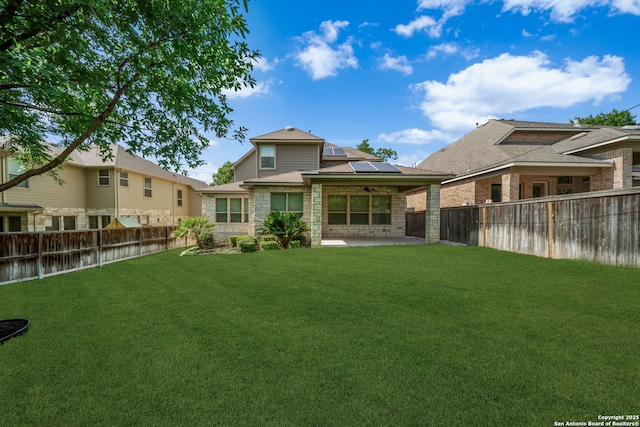 1702 Terra Alta, San Antonio, TX 78209 - back of property featuring ceiling fan, roof mounted solar panels, a patio, and stone siding