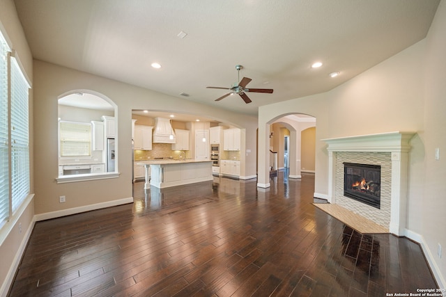 1702 Terra Alta, San Antonio, TX 78209 - unfurnished living room featuring a ceiling fan, a fireplace, dark wood-style floors, plenty of natural light, and recessed lighting