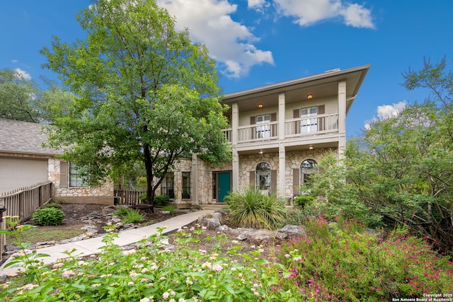 7 Mcinnis, Bulverde, TX 78163 - view of front of home with a balcony, stone siding, and a garage