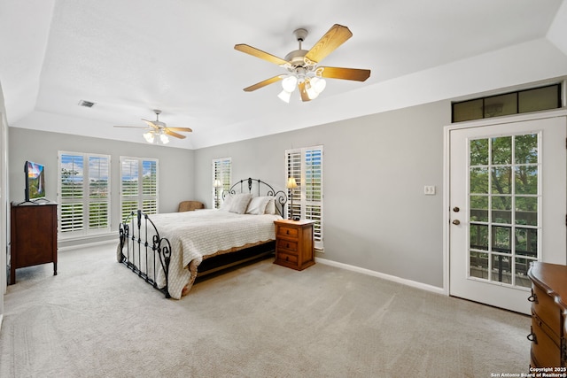 7 Mcinnis, Bulverde, TX 78163 - carpeted bedroom featuring access to exterior, multiple windows, a tray ceiling, and ceiling fan