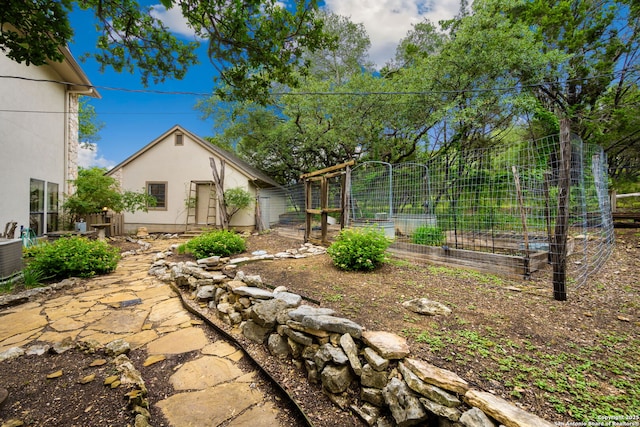 7 Mcinnis, Bulverde, TX 78163 - view of yard featuring a vegetable garden and an outbuilding