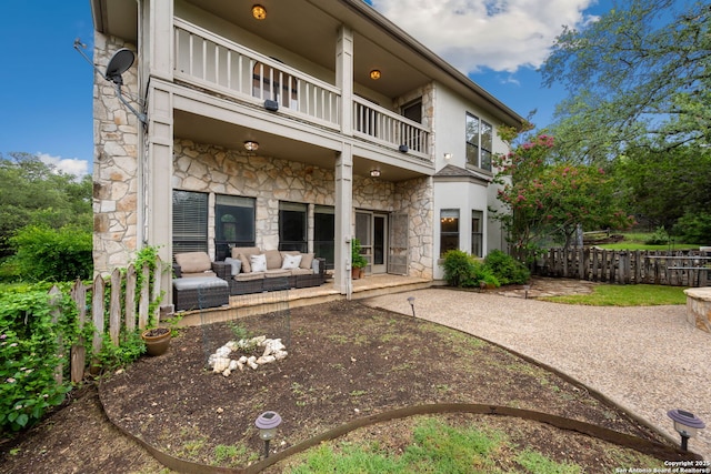 7 Mcinnis, Bulverde, TX 78163 - back of house featuring a balcony, stone siding, an outdoor hangout area, and a patio area