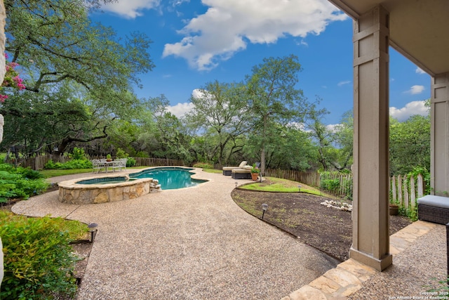 7 Mcinnis, Bulverde, TX 78163 - view of swimming pool with a patio area, a fenced backyard, and a pool with connected hot tub