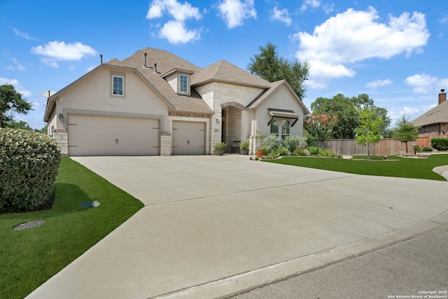 8903 Gate Pass, Boerne, TX 78015 - french country home featuring stone siding, concrete driveway, a garage, and stucco siding