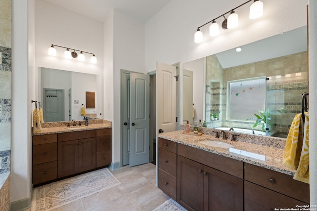 8903 Gate Pass, Boerne, TX 78015 - bathroom featuring a stall shower, two vanities, a bath, tile patterned floors, and lofted ceiling