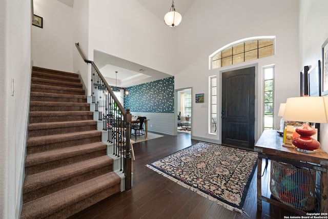 8903 Gate Pass, Boerne, TX 78015 - foyer featuring stairs, healthy amount of natural light, hardwood / wood-style flooring, a high ceiling, and wallpapered walls