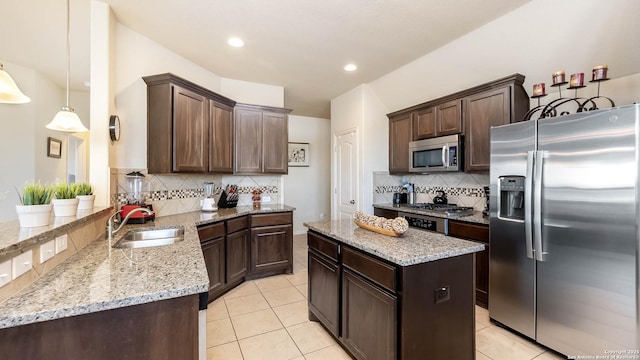 24514 Bliss Cyn, San Antonio, TX 78260 - kitchen with stainless steel appliances, light stone countertops, tasteful backsplash, dark brown cabinetry, and light tile patterned floors