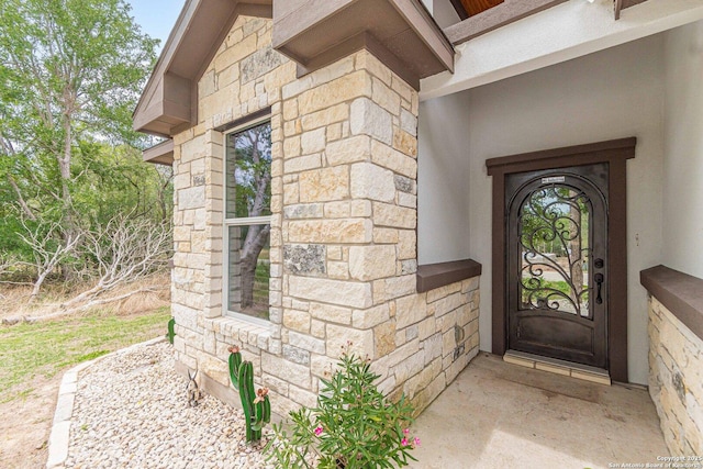 114 Mokukua Ln, Bastrop, TX 78602 - doorway to property featuring stone siding and stucco siding