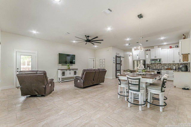 114 Mokukua Ln, Bastrop, TX 78602 - dining room featuring a ceiling fan and recessed lighting