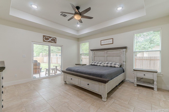 114 Mokukua Ln, Bastrop, TX 78602 - bedroom with a tray ceiling, access to outside, recessed lighting, a ceiling fan, and light tile patterned flooring