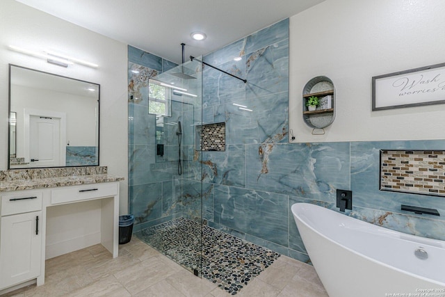 114 Mokukua Ln, Bastrop, TX 78602 - bathroom with a tile shower, a freestanding tub, and vanity