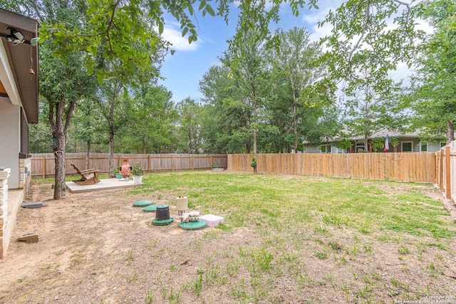 114 Mokukua Ln, Bastrop, TX 78602 - fenced backyard featuring a patio