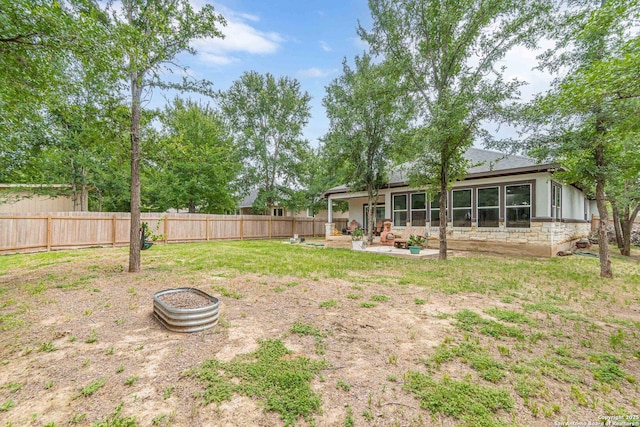 114 Mokukua Ln, Bastrop, TX 78602 - fenced backyard with a patio area