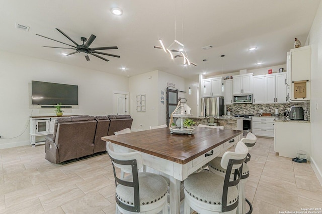 114 Mokukua Ln, Bastrop, TX 78602 - dining room featuring a ceiling fan and recessed lighting