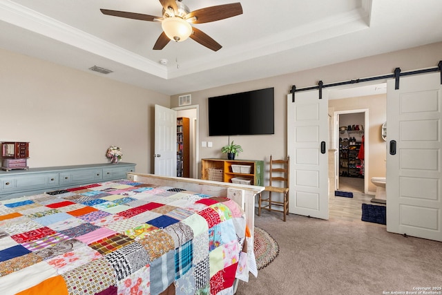 27306 Pollock, San Antonio, TX 78260 - bedroom with a barn door, a tray ceiling, light carpet, crown molding, and a ceiling fan
