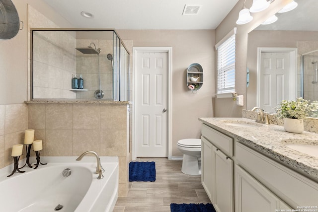 27306 Pollock, San Antonio, TX 78260 - full bath with a stall shower, double vanity, a bath, and wood finished floors