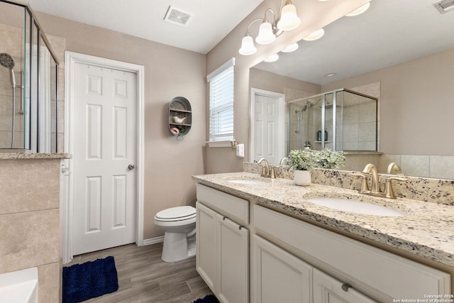 27306 Pollock, San Antonio, TX 78260 - full bathroom featuring a stall shower, double vanity, and wood finished floors