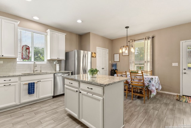 27306 Pollock, San Antonio, TX 78260 - kitchen with appliances with stainless steel finishes, light wood finished floors, tasteful backsplash, a chandelier, and recessed lighting