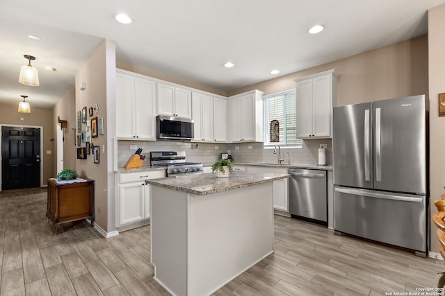 27306 Pollock, San Antonio, TX 78260 - kitchen with stainless steel appliances, light wood-style flooring, decorative backsplash, white cabinetry, and recessed lighting