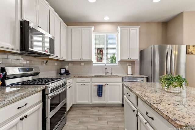 27306 Pollock, San Antonio, TX 78260 - kitchen featuring appliances with stainless steel finishes, white cabinets, tasteful backsplash, recessed lighting, and light stone counters