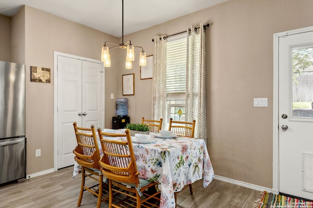 27306 Pollock, San Antonio, TX 78260 - dining room with light wood-style flooring and a chandelier