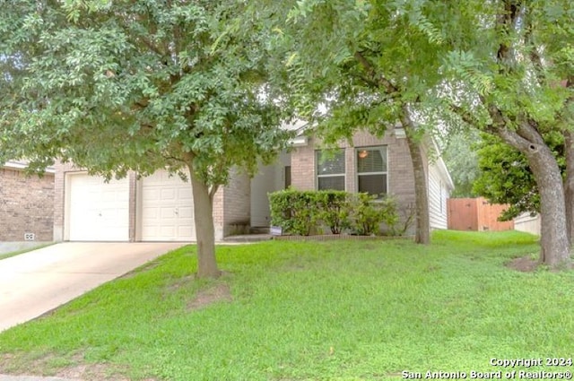 9522 Sage Ter, San Antonio, TX 78251 - view of property hidden behind natural elements featuring concrete driveway, brick siding, and an attached garage
